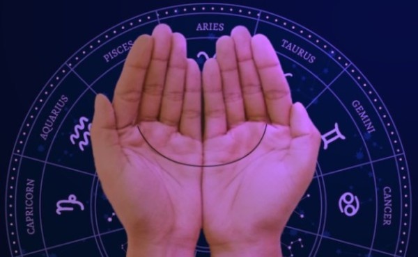 Palm and zodiac symbols representing a horoscope reading
